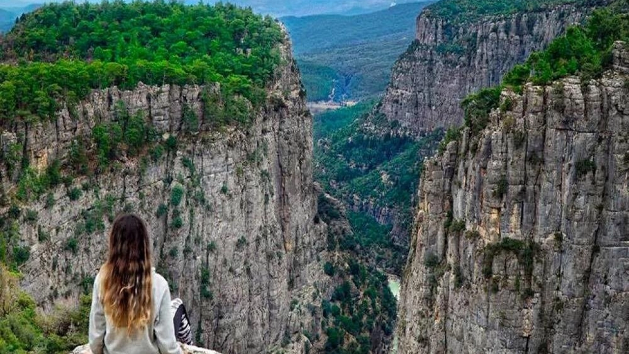 Open-top Cabrio Bus driving through mountain scenery